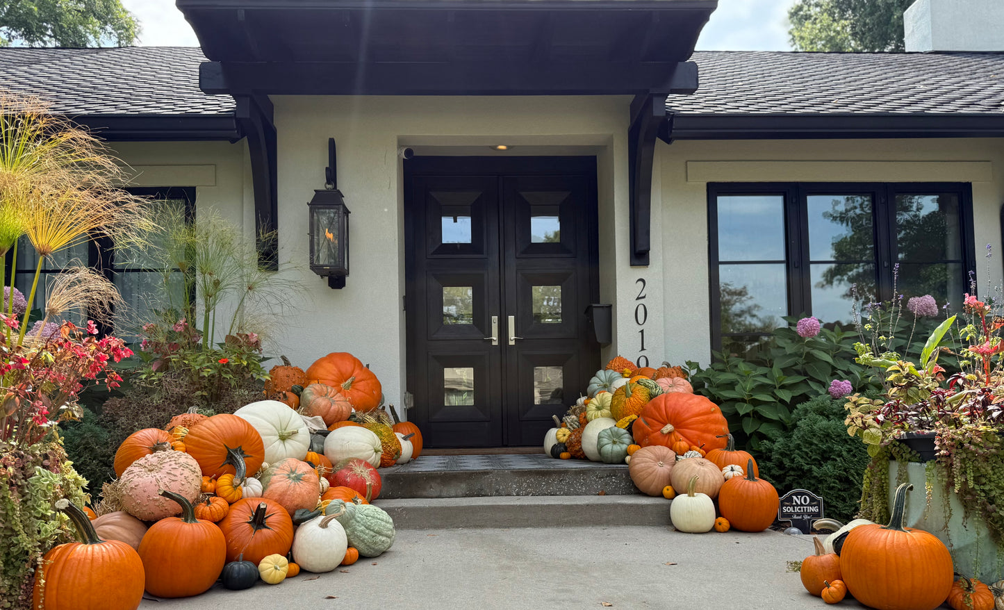front porch overflowing with pumpkins from Mum & Gourd largest porch pumpkins package in Kansas City