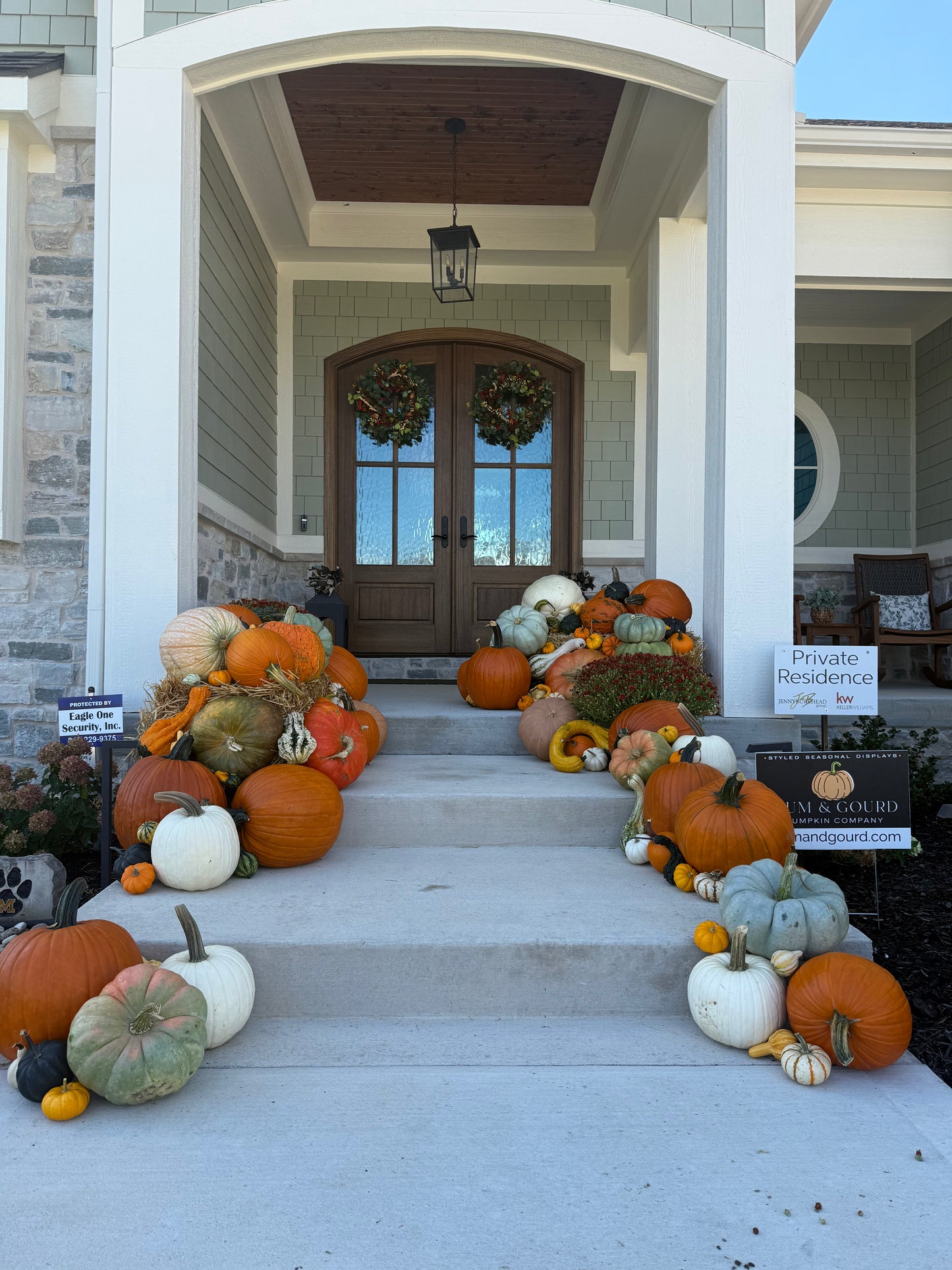 Porch pumpkin display in Kansas City beautifully arranged fall decor styled by Mum & Gourd